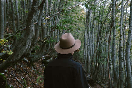 Man wearing hat gloves looking away. Travel coceptの写真素材