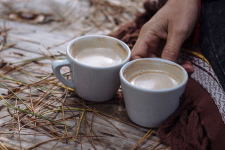 Two cups of coffee on a cut treeの写真素材