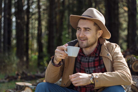 Man cowboy hat drinking morning coffee in countrysideの写真素材