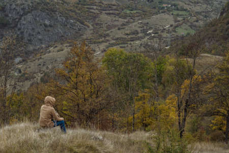 Traveller man in autumn mountains
