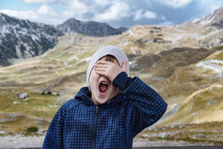 Little explorer  hiking in autumn mountainsの写真素材