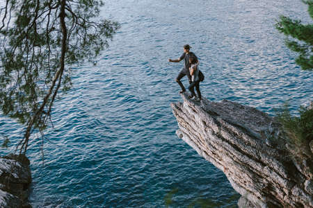 Happy Man and women sit down on a rock mountain in Montenegro, freedom coceptの写真素材