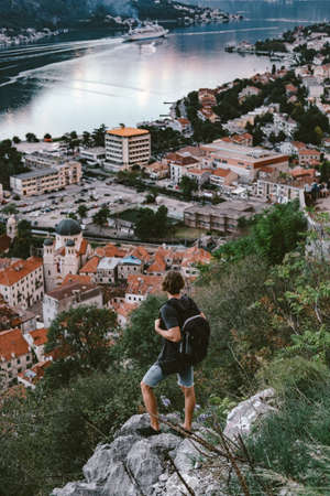 Traveler standing on a mountain and looking on evening the old town of Kotor, Montenegroの写真素材