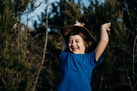 Smiling boy outdoor in summer forest. 6 years old kid in hat playing in nature.の写真素材