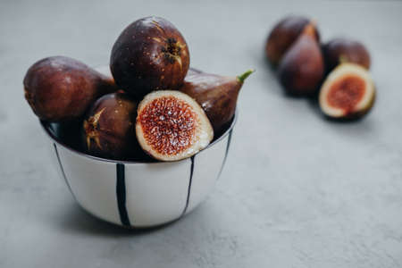 Fresh figs in bawl on gray backgroundの写真素材