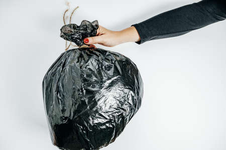 Waste management concept. Woman Hands With garbage on the White Background. Top Viewの写真素材
