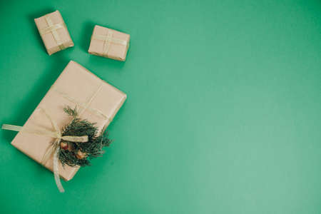 Christmas gift, pine cones, thuja branches on Green Background Flat lay, top view, copy spaceの写真素材