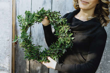 Christmas wreath on woman handsの写真素材
