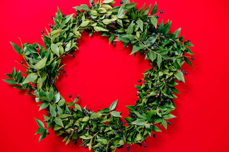 Christmas wreath on red background. Top Viewの写真素材
