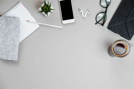 Top view of stationery and telephone, coffee  on grey desktop background. Business conceptの写真素材