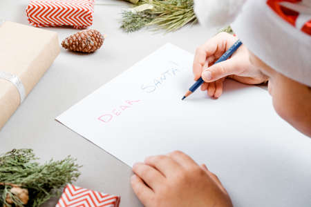 Letter for Santa. Boy Hands on paper, gifts and marshmallows. Top view, flat layの写真素材