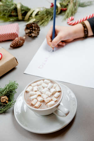 Cocoa with marshmallow and Boy writing letter to Santa Claus at Christmas. Top view.の写真素材