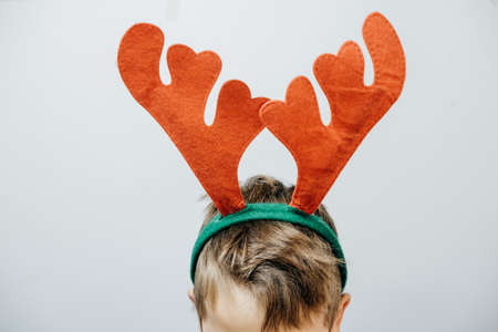 Cute boy in a red deer horns. Christmas conceptの写真素材