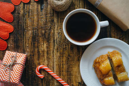 Christmas cake with Coffee and gifts on wooden table. Top view, flat layの写真素材