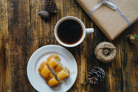 Christmas cake with Coffee and gifts on wooden table. Top view, flat layの写真素材