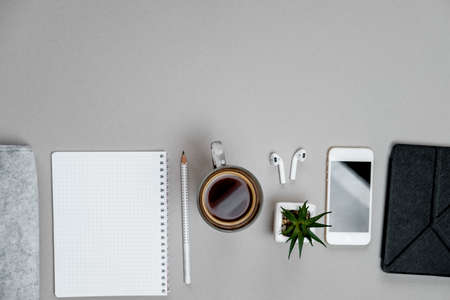 Top view of stationery and telephone, coffee  on grey desktop background. Business conceptの写真素材