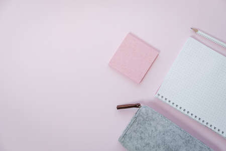 Phone and stationery on pink table. Business concept. Top view, flat layの写真素材