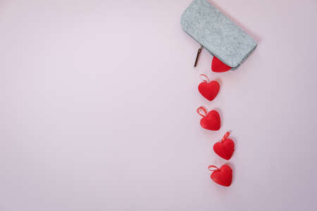 Valentine's Day. Hearts in a gray case on a pink background. Flat layの写真素材