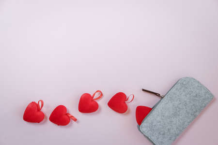 Valentine's Day. Hearts in a gray case on a pink background. Flat layの写真素材