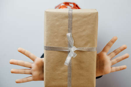 Cute boy in red santa hat with gift. Christmas conceptの写真素材