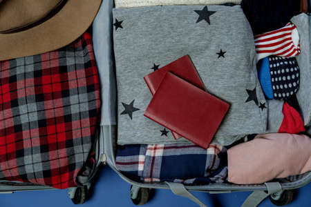 Open suitcase packed for travelling. Winter vacations and holidays. Top viewの写真素材