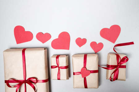 Preparation for Valentine day with gift boxes, red ribbon and hearts on white background. Top view, flat layの写真素材