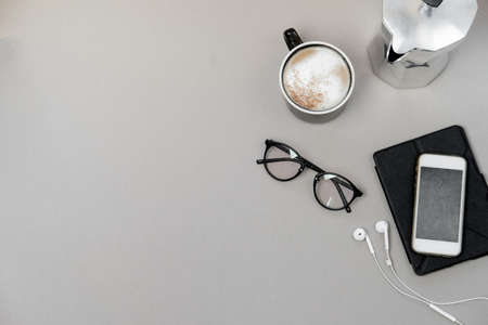 Grey wood office desk table and equipment for working, phone and coffee. Top view, Flat lay