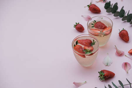 Soda with strawberries on a pink background. Summer refreshing drink. Top viewの写真素材