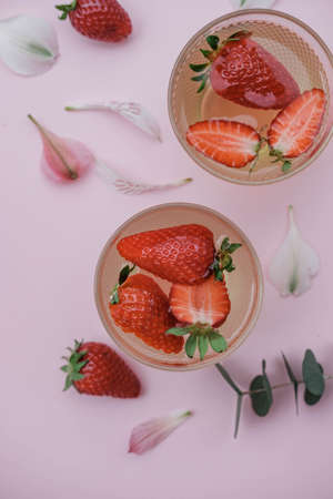 Soda with strawberries on a pink background. Summer refreshing drink. Top viewの写真素材