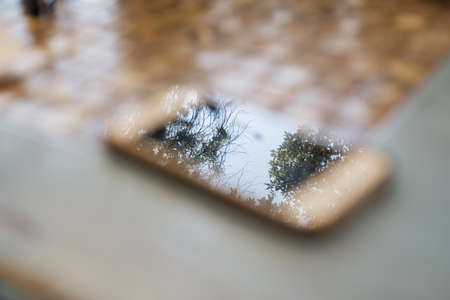 Blurred photo of the phone on the deskの写真素材