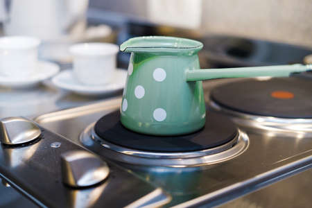 Turk with coffee on the stove. The process of making Turkish coffeeの写真素材