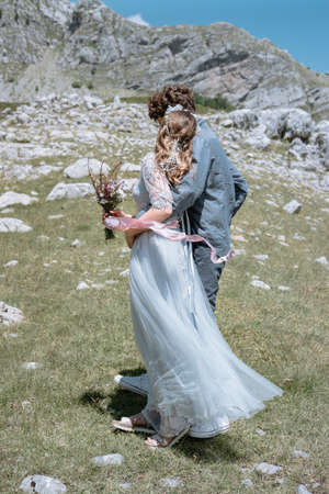 Stylish Romantic  couple against the background of the mountains.の写真素材