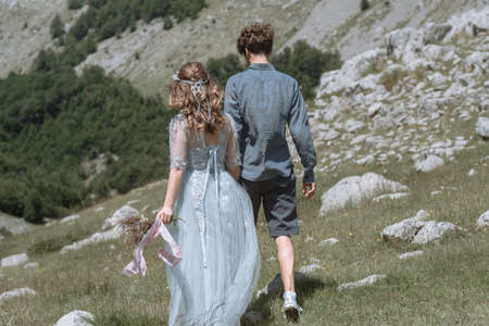 Romantic  couple walking along background of the mountains.の写真素材