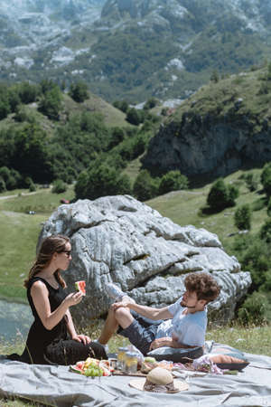 Romantic  couple walking against the background of the mountains.の写真素材