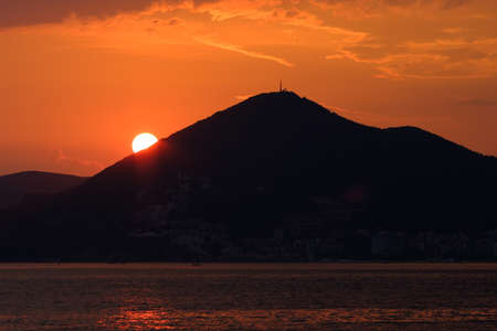 Beautiful sunset at the sea with a view of the mountains. Montenegro, the Adriatic Sea, the Balkans.の写真素材
