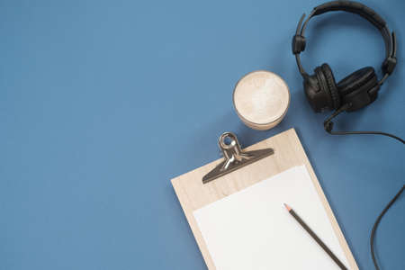 Flat lay composition with Headphones, microphone and coffee on a blue background. Podcast or webinar concept.の写真素材