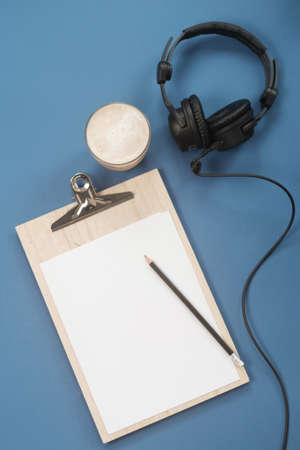 Flat lay composition with Headphones, microphone and coffee on a blue background. Podcast or webinar concept.の写真素材