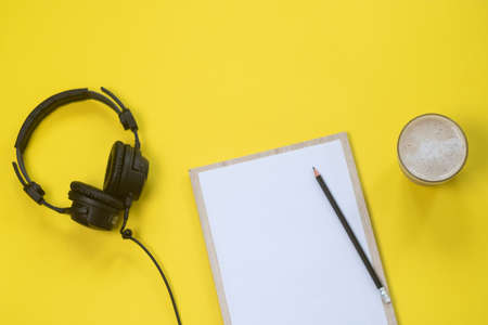 Flat lay composition with Headphones, microphone and coffee on a yellow background. Podcast or webinar concept.の写真素材