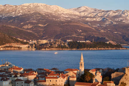 View of Budva, the old town in Montenegro at sunset and snow-capped mountainsの写真素材