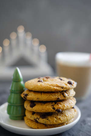 Christmas cookies with chocolate on the background of candles.の写真素材