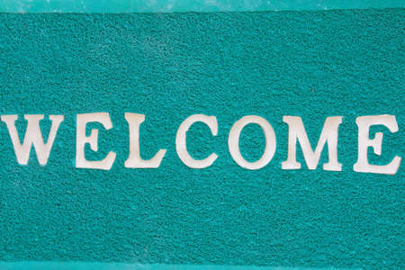green door mat with welcome の写真素材