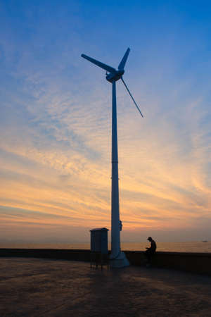 Sunset And Wind Turbineの写真素材