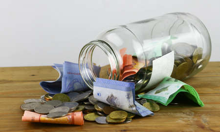Coins and notes with glass jar