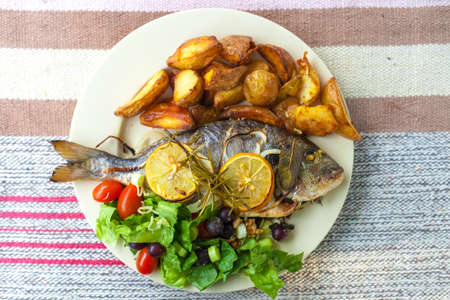 Fish, salad and patatoの写真素材