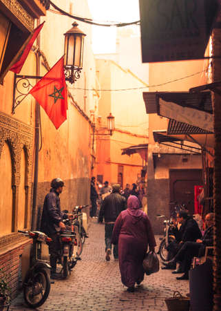 Beautiful light and great atmosphere in one of the many old historical little roads through the souk the nearby bazaar to Djemma El Fna Square のeditorial素材