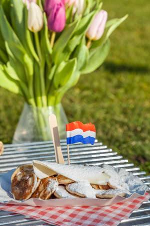 Small Dutch pancakes served with butter, suger and a Dutch flag.の写真素材