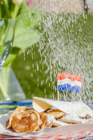 Small Dutch pancakes served with butter, suger and a Dutch flag.の写真素材