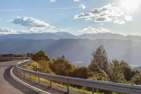 Mountain road through New Zealand with nice sun lightの写真素材