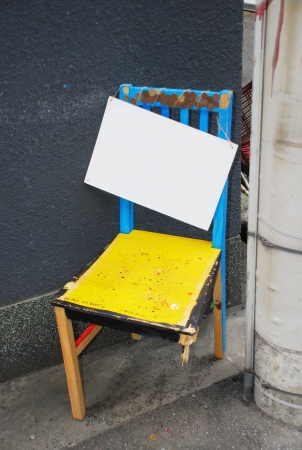 Empty sign hanging on Old broken chairの写真素材