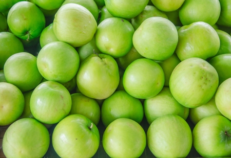 close-up of raw green apple heap in the marketの写真素材